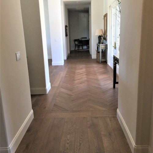 Hallway with herringbone wood flooring