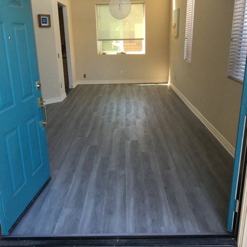 Small home with bright blue doors and grey LVP flooring